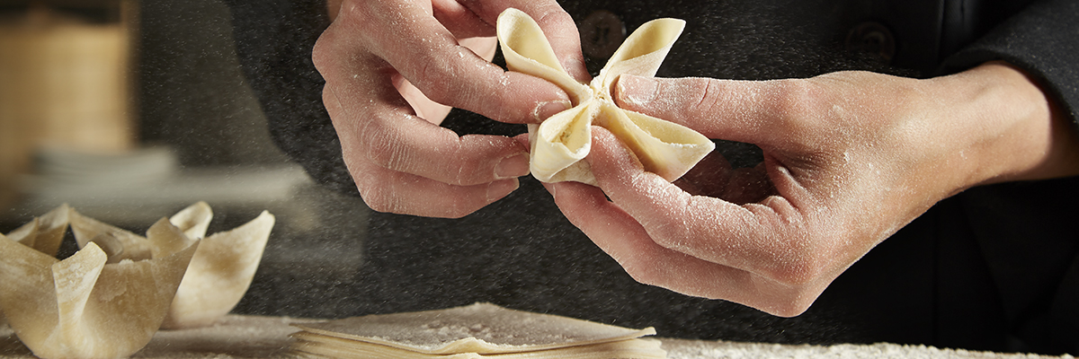 Close-up of P.F. Chang's chef hands delicately folding wontons