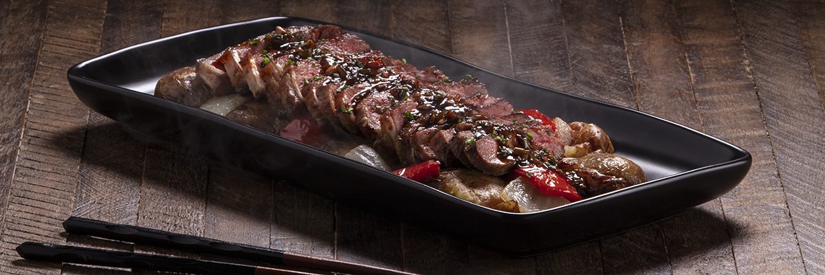 P.F. Chang's Korean Bulgogi Steak entrée on table next to dark-colored chopsticks